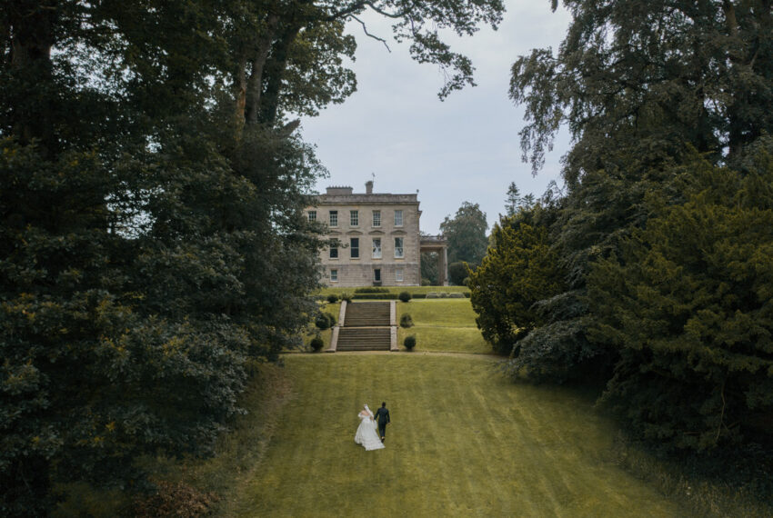 bridal couple walking towards Hilton Park