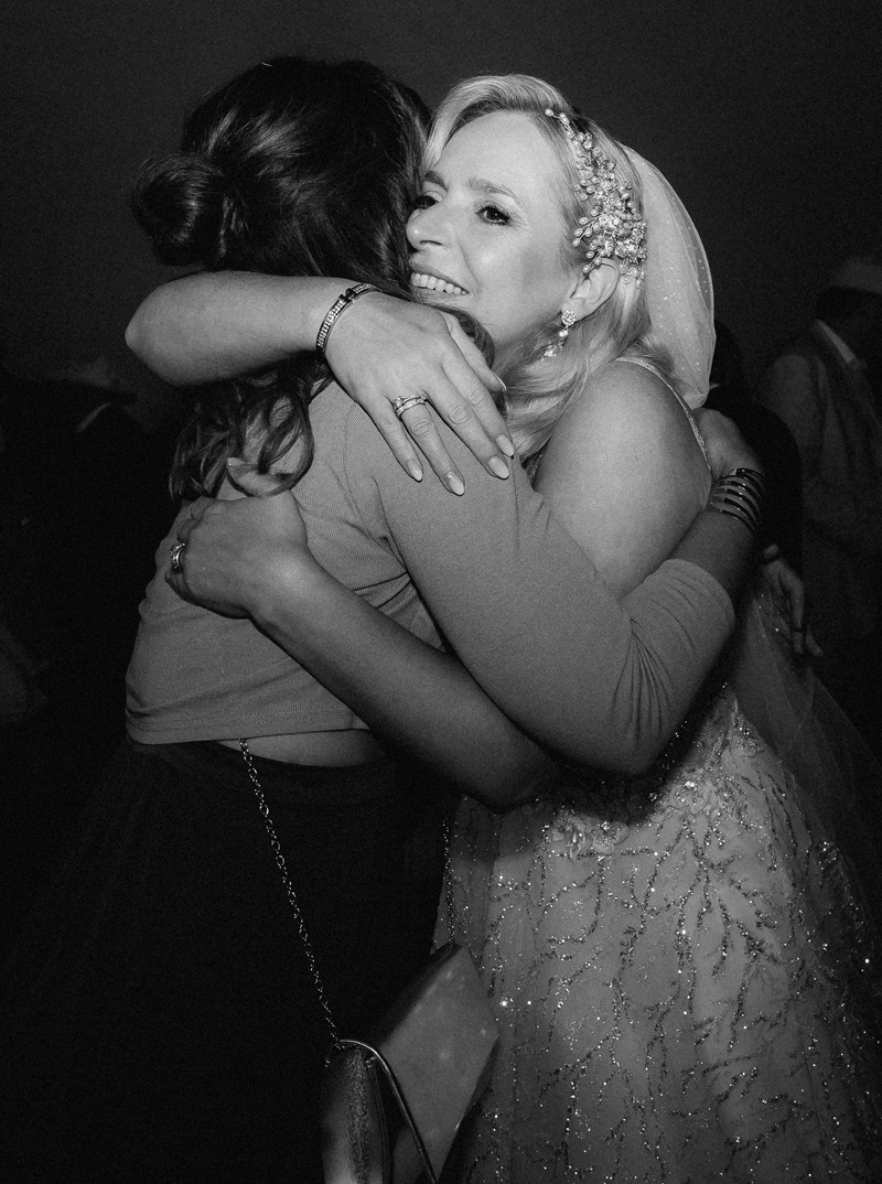 Guest gratulating bride during champagne reception