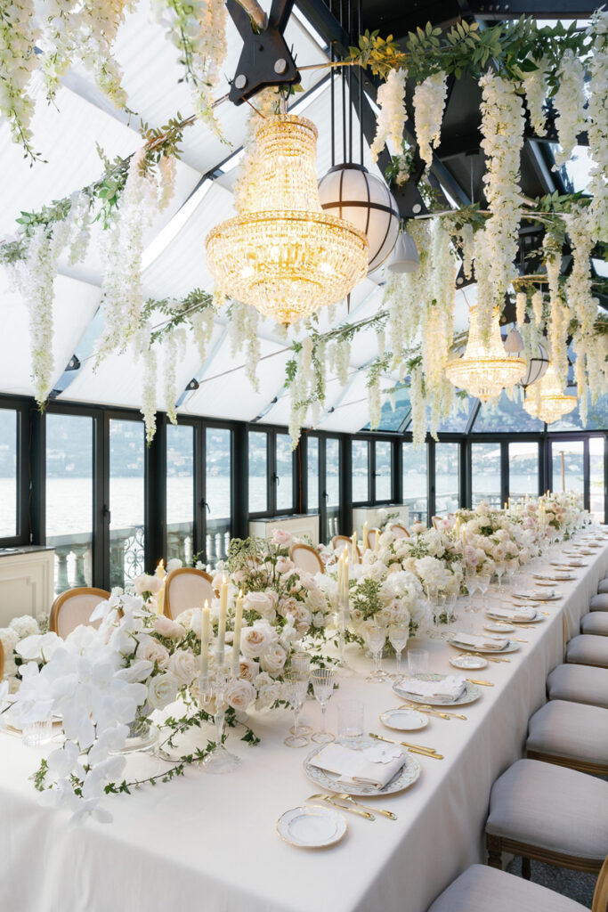 Dinner Decoration at the Greenhouse - Mandarin Oriental, Lake Como. The Picture shows the whole room with ceiling decoration additional chandeliers, the dinner table, chairs and the floral arrangements in the room