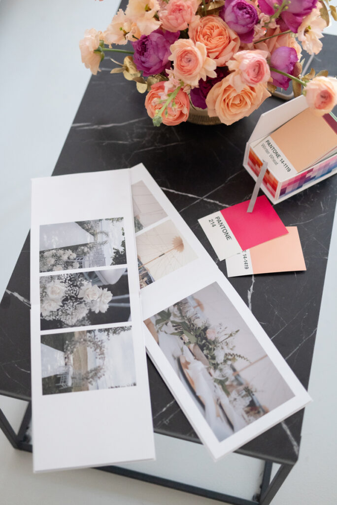 Photo albums and pantone color cards with a flower arrangements