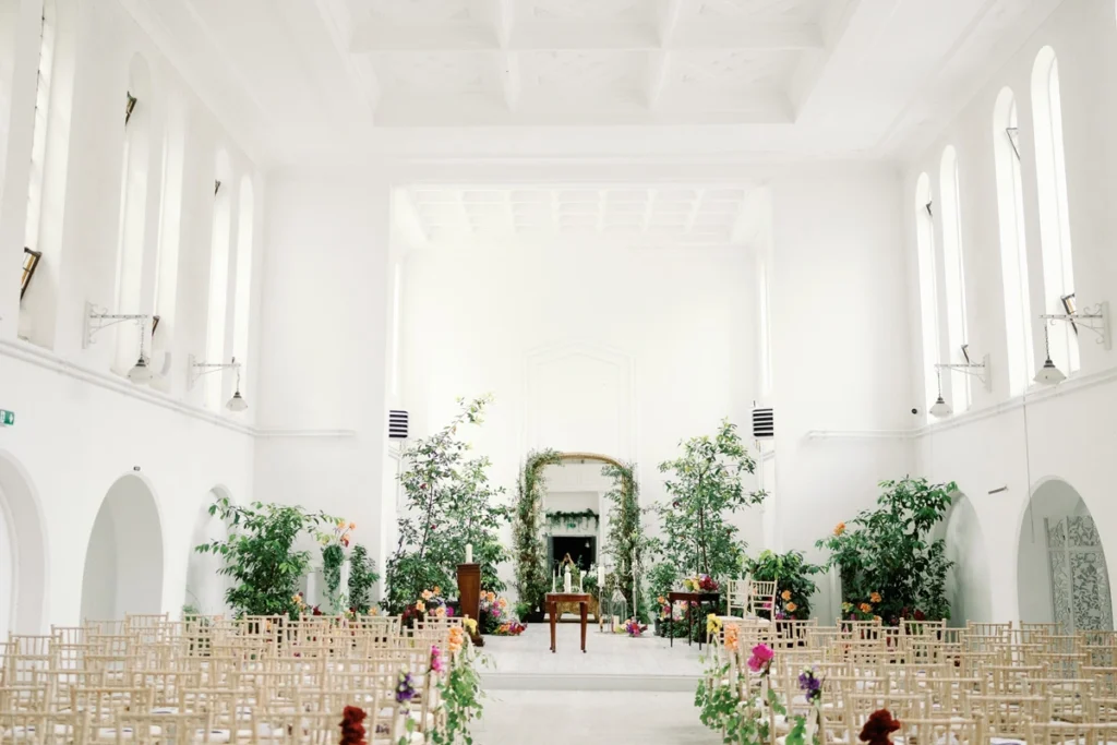 Wide angle view of rowed chairs and the altar area setup for a Gloster House wedding ceremony
