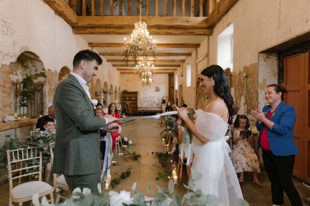A refined Celtic handfasting ritual with bespoke ribbons during a luxury wedding ceremony in Ireland.