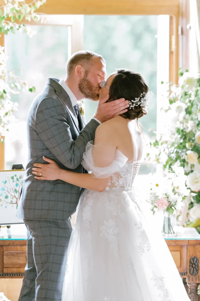 Newlywed couple kissing warmly at the altar after saying their wedding vows inside Castle Leslie
