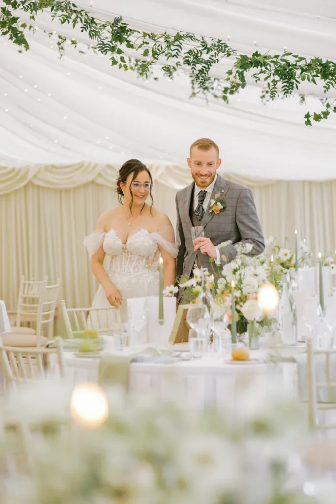 Smiling bride and groom walking through the decorated Pavilion during their private reception room reveal